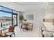 Modern dining area with white chairs and a wooden table at 1558 4Th St # 402, Sarasota, FL 34236