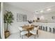 Modern dining area with wooden table and four cushioned chairs at 1558 4Th St # 402, Sarasota, FL 34236