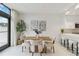 Modern dining area with wooden table and four cushioned chairs at 1558 4Th St # 402, Sarasota, FL 34236