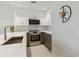 Modern kitchen featuring stainless steel appliances and wood cabinets at 1558 4Th St # 402, Sarasota, FL 34236