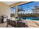 Relaxing poolside dining area with patio furniture and a built-in grill at 16722 Collingtree Xing, Lakewood Ranch, FL 34202