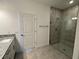 Bathroom with walk-in shower, tile flooring, and granite vanity at 18059 Cherished Loop, Bradenton, FL 34211