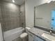 Bathroom with tub, shower, granite countertop, and single sink at 18059 Cherished Loop, Bradenton, FL 34211