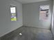 Bright bedroom with two windows, grey carpeting, and neutral walls at 18059 Cherished Loop, Bradenton, FL 34211