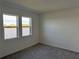 Spacious bedroom with gray carpet and large windows with lake view at 18059 Cherished Loop, Bradenton, FL 34211