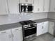 Modern kitchen featuring stainless steel appliances and granite countertops at 18059 Cherished Loop, Bradenton, FL 34211