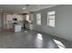 Open living space with kitchen and gray tile flooring at 18059 Cherished Loop, Bradenton, FL 34211