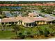 Community clubhouse with surrounding landscape at 206 Bella Vista Ter # 29B, North Venice, FL 34275