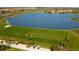 Golf course with lake and players at 206 Bella Vista Ter # 29B, North Venice, FL 34275