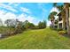 Landscaped backyard with grassy area and pond view at 206 Bella Vista Ter # 29B, North Venice, FL 34275