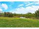Green backyard space with pond view at 206 Bella Vista Ter # 29B, North Venice, FL 34275