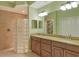 Bathroom with double vanity, granite countertop, glass shower at 206 Bella Vista Ter # 29B, North Venice, FL 34275