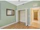 Bedroom with mirrored closet doors and access to hallway at 206 Bella Vista Ter # 29B, North Venice, FL 34275