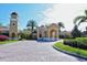 Community clubhouse with clock tower and courtyard at 206 Bella Vista Ter # 29B, North Venice, FL 34275