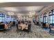 Elegant dining room with large windows and chandeliers at 206 Bella Vista Ter # 29B, North Venice, FL 34275