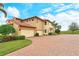 Home features a three-car garage and brick paver driveway at 206 Bella Vista Ter # 29B, North Venice, FL 34275