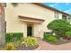 Inviting entryway with dark green door and brick walkway at 206 Bella Vista Ter # 29B, North Venice, FL 34275