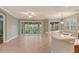 Spacious kitchen with breakfast bar, tile flooring, and sliding doors to patio at 206 Bella Vista Ter # 29B, North Venice, FL 34275
