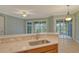 Kitchen island with sink, granite countertop, view to backyard at 206 Bella Vista Ter # 29B, North Venice, FL 34275