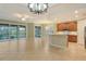 L-shaped kitchen with island and wood cabinets at 206 Bella Vista Ter # 29B, North Venice, FL 34275