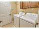 Laundry room with washer, dryer, and overhead cabinets at 206 Bella Vista Ter # 29B, North Venice, FL 34275