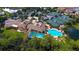 Resort-style pool and clubhouse with surrounding lush landscaping at 206 Bella Vista Ter # 29B, North Venice, FL 34275