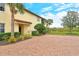 Side entry with brick paver walkway and landscaping at 206 Bella Vista Ter # 29B, North Venice, FL 34275
