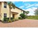 Inviting side entry with brick paver walkway and landscaping at 206 Bella Vista Ter # 29B, North Venice, FL 34275