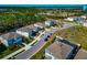 A peaceful neighborhood showcases modern homes along with lush greenery, ponds, and clear blue skies at 2164 Midnight Pearl Dr, Sarasota, FL 34240