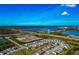 Stunning aerial view showcasing the community's proximity to a large lake and green spaces at 2164 Midnight Pearl Dr, Sarasota, FL 34240