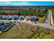 A residential area with a scenic pond backdrop, featuring new homes, landscaped yards, and an open layout at 2164 Midnight Pearl Dr, Sarasota, FL 34240