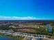 Gorgeous aerial view of community with lush landscaping, water features and blue skies at 2164 Midnight Pearl Dr, Sarasota, FL 34240