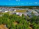 Aerial shot featuring lush green trees and landscaping with beautiful nearby lakes at 2164 Midnight Pearl Dr, Sarasota, FL 34240