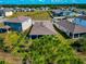 Aerial view of the back exterior featuring a screened-in patio and well-maintained lawn at 2164 Midnight Pearl Dr, Sarasota, FL 34240