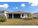Home's backyard featuring a screened lanai, green lawn, and well-maintained landscaping at 2164 Midnight Pearl Dr, Sarasota, FL 34240