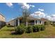 Home's backyard featuring a screened lanai, green lawn, and well-maintained landscaping at 2164 Midnight Pearl Dr, Sarasota, FL 34240