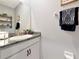 Bathroom vanity with a granite countertop, white cabinets, and modern fixtures at 2164 Midnight Pearl Dr, Sarasota, FL 34240