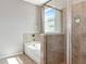 Bathroom featuring a shower, tub, and tile floor at 2164 Midnight Pearl Dr, Sarasota, FL 34240