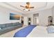 Bedroom features a TV, carpet, and a walk-in closet at 2164 Midnight Pearl Dr, Sarasota, FL 34240