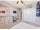 This lovely bedroom features neutral walls, a ceiling fan, with a dresser and desk near the closet at 2164 Midnight Pearl Dr, Sarasota, FL 34240