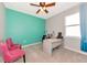 Inviting bedroom featuring neutral walls, a ceiling fan, and a desk with chair near the window at 2164 Midnight Pearl Dr, Sarasota, FL 34240