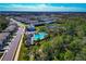 Aerial view of a residential community with a large pool and clubhouse amidst lush greenery at 2164 Midnight Pearl Dr, Sarasota, FL 34240