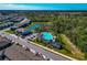 Overhead shot featuring a pool, clubhouse, and residential neighborhood in a community setting at 2164 Midnight Pearl Dr, Sarasota, FL 34240