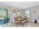 Bright dining room with large table, bench seating, and sliding glass doors to the outdoors at 2164 Midnight Pearl Dr, Sarasota, FL 34240