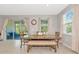 Inviting dining area features a wooden table, bench seating, and sliding door to the outside at 2164 Midnight Pearl Dr, Sarasota, FL 34240