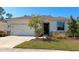 Lovely single-story home with a well-kept lawn, stone accents, a black front door, and a two car garage at 2164 Midnight Pearl Dr, Sarasota, FL 34240