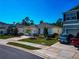 Home featuring a two-car garage, manicured landscaping, and a well-maintained lawn at 2164 Midnight Pearl Dr, Sarasota, FL 34240