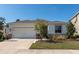 Charming single-story home with a well-manicured lawn and a two car garage on a sunny day at 2164 Midnight Pearl Dr, Sarasota, FL 34240