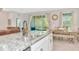 Kitchen island with stainless steel sink overlooks dining area and outdoor patio at 2164 Midnight Pearl Dr, Sarasota, FL 34240