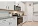 Modern kitchen equipped with stainless steel oven and microwave, accented by white cabinets at 2164 Midnight Pearl Dr, Sarasota, FL 34240